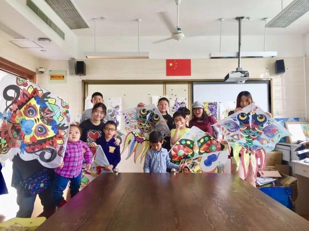 自闭症关怀志愿者与自闭症儿童一起制作风筝.jpg