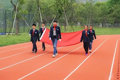 同学们步伐整齐的护送国旗